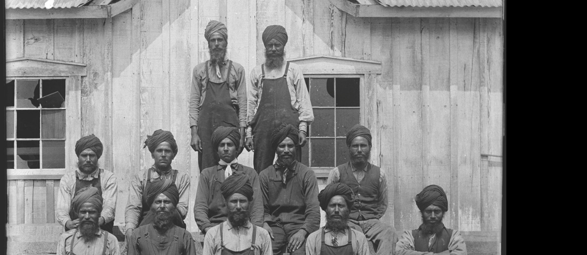 Black-and-white-photo-of-Sikh-Sawmill-Workers-in-front-of-a-building-in-Vancouver