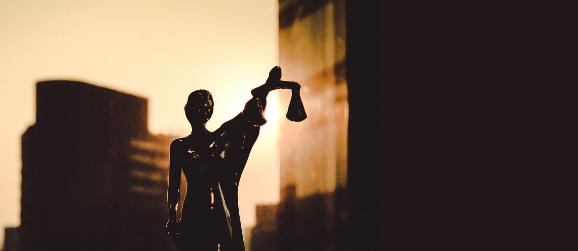 Silhouette-of-Woman-Holding-Scales-Of-Justice-with-City-Building-in-Background