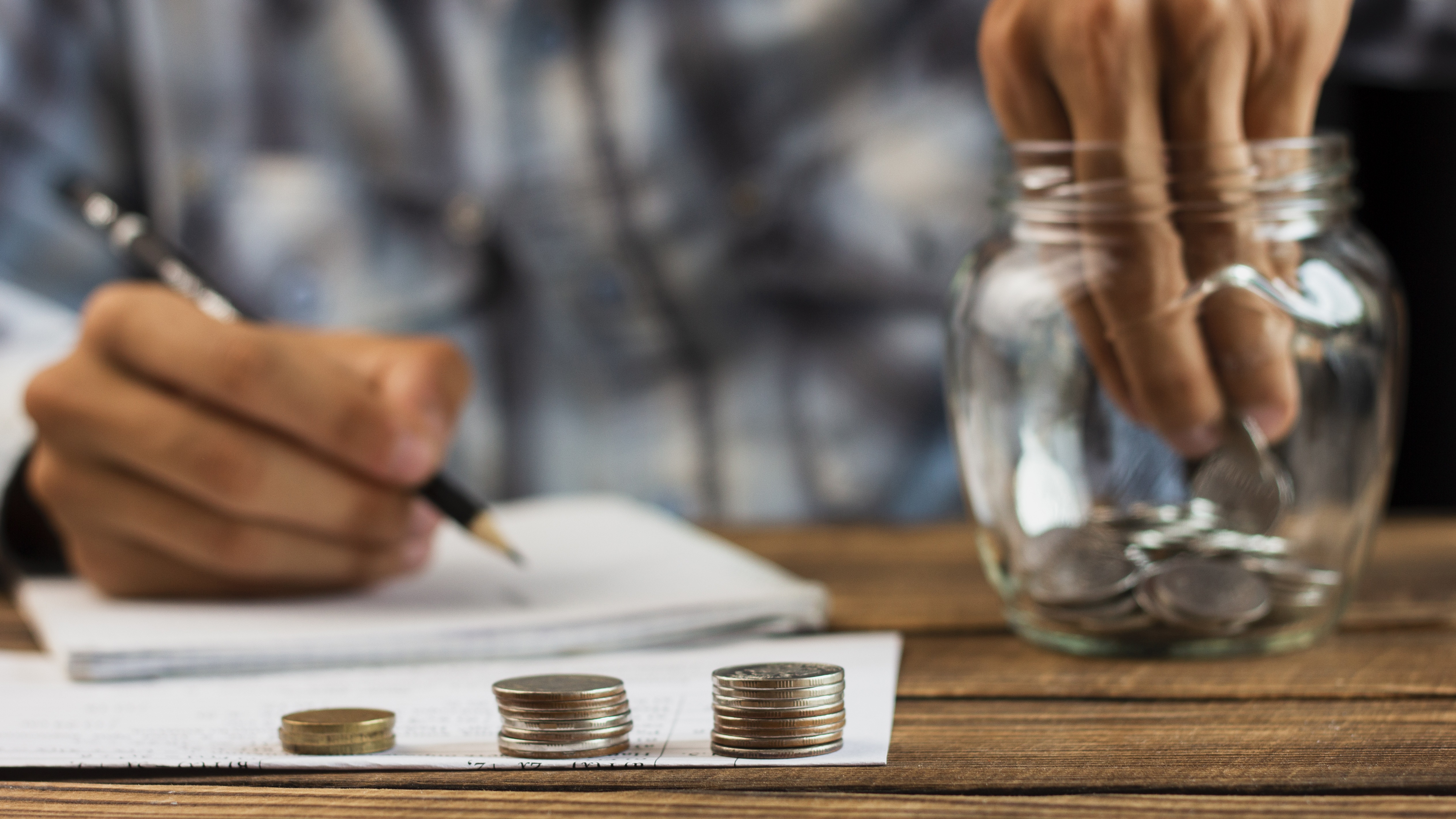 man-taking-out-coins-from-saving-jar