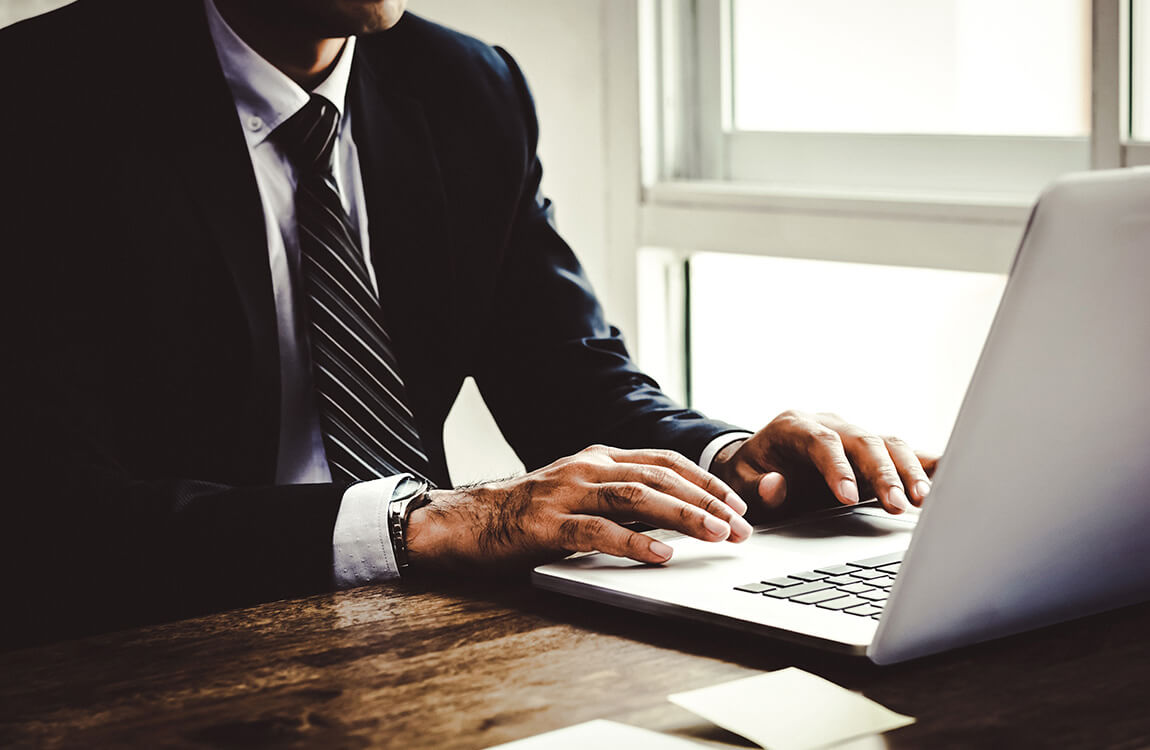 Businessman typing on laptop